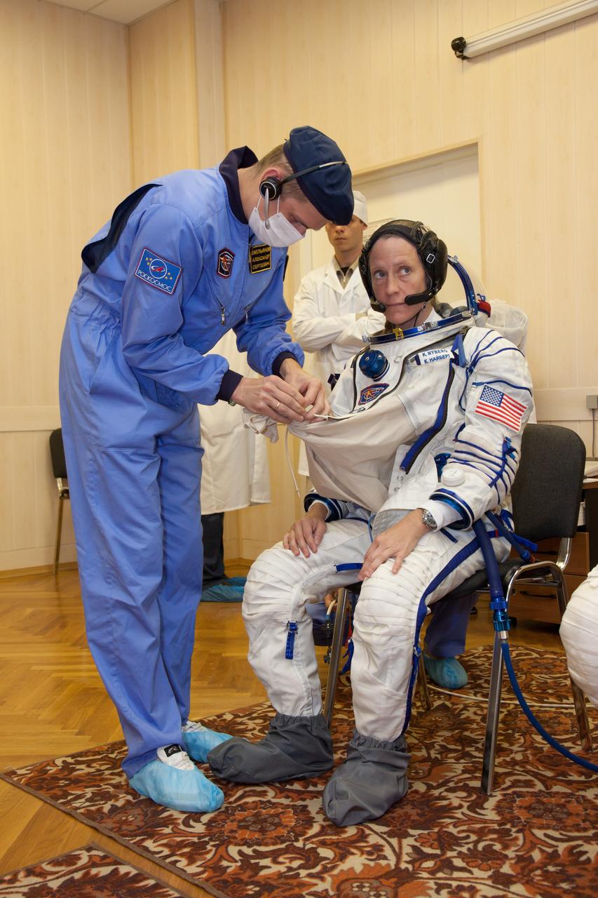 In the Integration Facility at the Baikonur Cosmodrome in Kazakhstan, Expedition 36/37 Flight Engineer Karen Nyberg of NASA suits up for a dress rehearsal exercise May 17 during a suited “fit check”. Nyberg, Soyuz Commander Fyodor Yurchikhin and Flight Engineer Luca Parmitano of the European Space Agency will launch May 29, Kazakh time, in their Soyuz TMA-09M spacecraft to begin a 5 ½ mission on the International Space Station.  NASA/Victor Zelentsov 