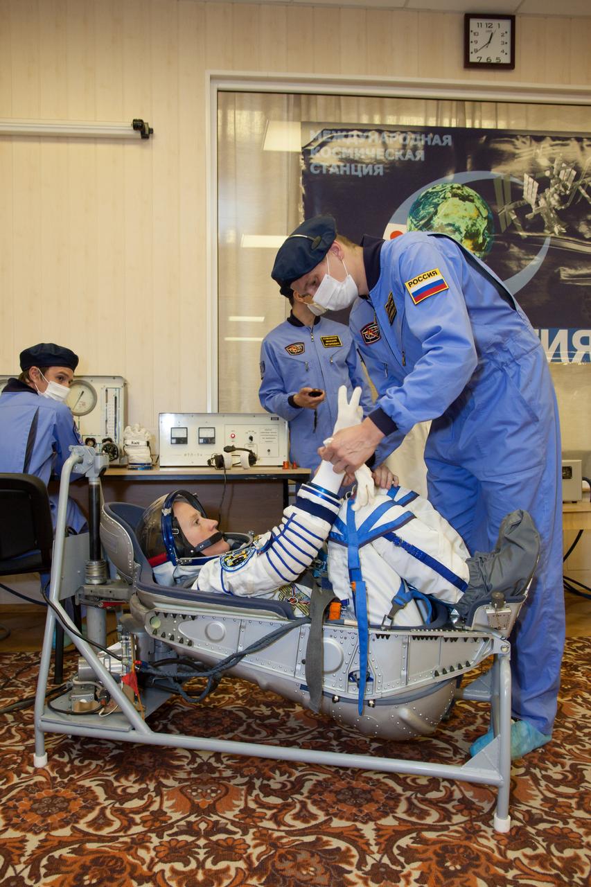 In the Integration Facility at the Baikonur Cosmodrome in Kazakhstan, Expedition 36/37 Flight Engineer Karen Nyberg of NASA checks her gloves during a portion of a suited dress rehearsal “fit check” exercise May 17. Nyberg, European Space Agency Flight Engineer Luca Parmitano and Soyuz Commander Fyodor Yurchikhin will launch May 29, Kazakh time, in their Soyuz TMA-09M spacecraft to begin a 5 ½ mission on the International Space Station. NASA/Victor Zelentsov