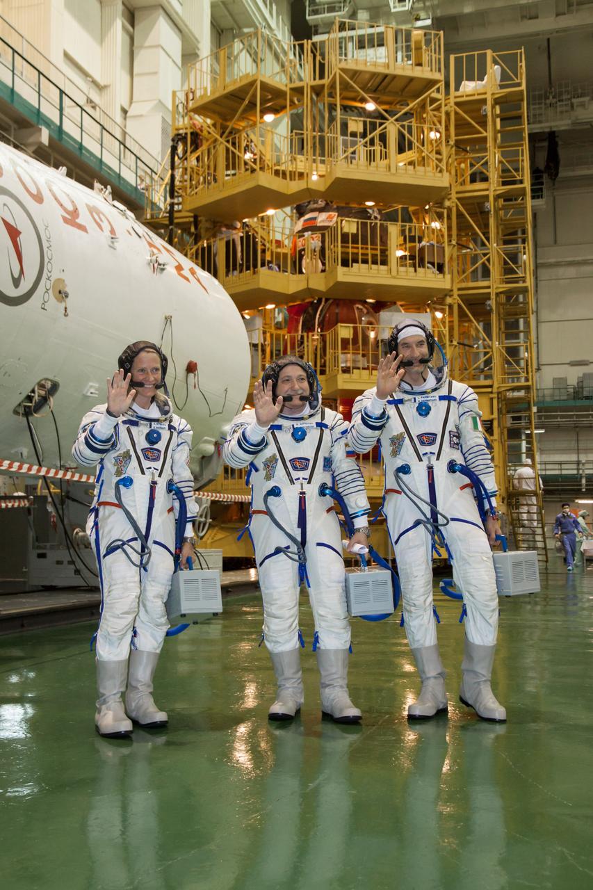 In the Integration Facility at the Baikonur Cosmodrome in Kazakhstan, Expedition 36/37 Flight Engineer Karen Nyberg of NASA (left), Soyuz Commander Fyodor Yurchikhin (center) and Flight Engineer Luca Parmitano of the European Space Agency (right) pose for pictures during a suited dress rehearsal “fit check” exercise May 17. The trio will launch May 29, Kazakh time, in their Soyuz TMA-09M spacecraft to begin a 5 ½ month mission on the International Space Station.  NASA/Victor Zelentsov 