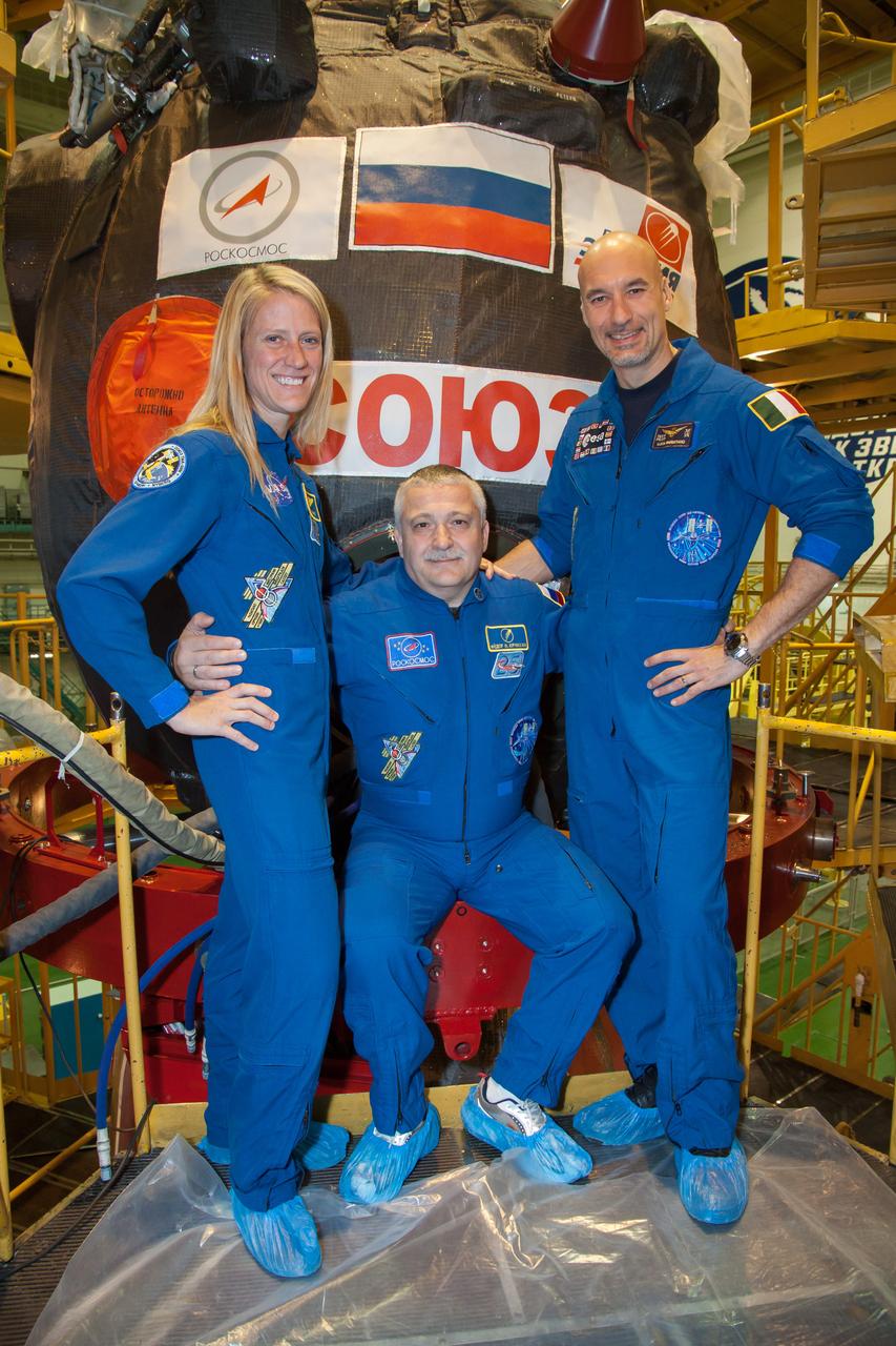 In the Integration Facility at the Baikonur Cosmodrome in Kazakhstan, Expedition 36/37 Flight Engineer Karen Nyberg of NASA (left), Soyuz Commander Fyodor Yurchikhin (center) and Flight Engineer Luca Parmitano of the European Space Agency (right) pose for pictures during a suited dress rehearsal “fit check” exercise May 17. The trio will launch May 29, Kazakh time, in their Soyuz TMA-09M spacecraft to begin a 5 ½ month mission on the International Space Station.  NASA/Victor Zelentsov 
