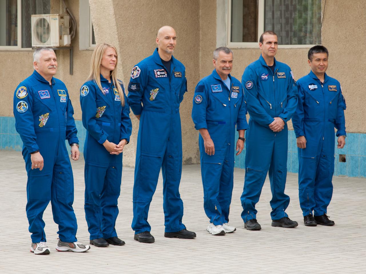 Outside their Cosmonaut Hotel crew quarters in Baikonur, Kazakhstan, the Expedition 36/37 prime and backup crewmembers conducted the traditional raising of flags of their countries and host country Kazakhstan May 18 and participated in other ceremonies. From left to right are prime Soyuz Commander Fyodor Yurchikhin, prime Flight Engineer Karen Nyberg of NASA, prime Flight Engineer Luca Parmitano of the European Space Agency, and backup crewmembers Mikhail Tyurin, Rick Mastracchio of NASA and Flight Engineer Koichi Wakata of the Japan Aerospace Exploration Agency. Nyberg, Yurchikhin and Parmitano are preparing for launch May 29, Kazakh time, in their Soyuz TMA-09M spacecraft to begin a 5 ½ month mission on the International Space Station.  NASA/Victor Zelentsov 