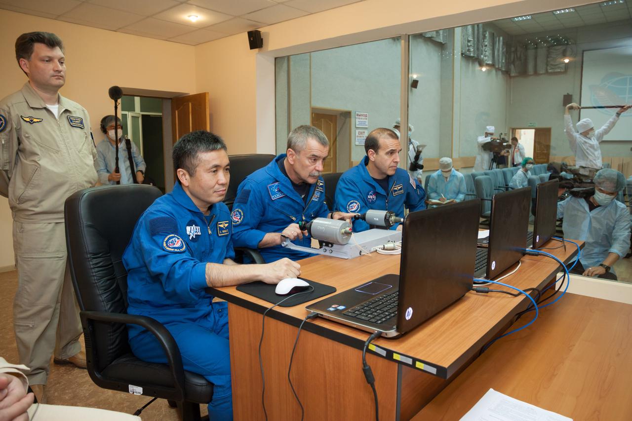 In the Cosmonaut Hotel crew quarters in Baikonur, Kazakhstan, Expedition 36/37 backup Soyuz Commander Mikhail Tyurin (center) practices a Soyuz docking on a laptop simulator May 22 as he and his backup crewmates, Flight Engineer Koichi Wakata of the Japan Aerospace Exploration Agency (left) and Flight Engineer Rick Mastracchio of NASA look on. The trio is serving as backups to Karen Nyberg of NASA, Luca Parmitano of the European Space Agency and Fyodor Yurchikhin, who are preparing for their launch May 29, Kazakh time, in the Soyuz TMA-09M spacecraft to begin a 5 ½ month mission on the International Space Station.  NASA/Victor Zelentsov 