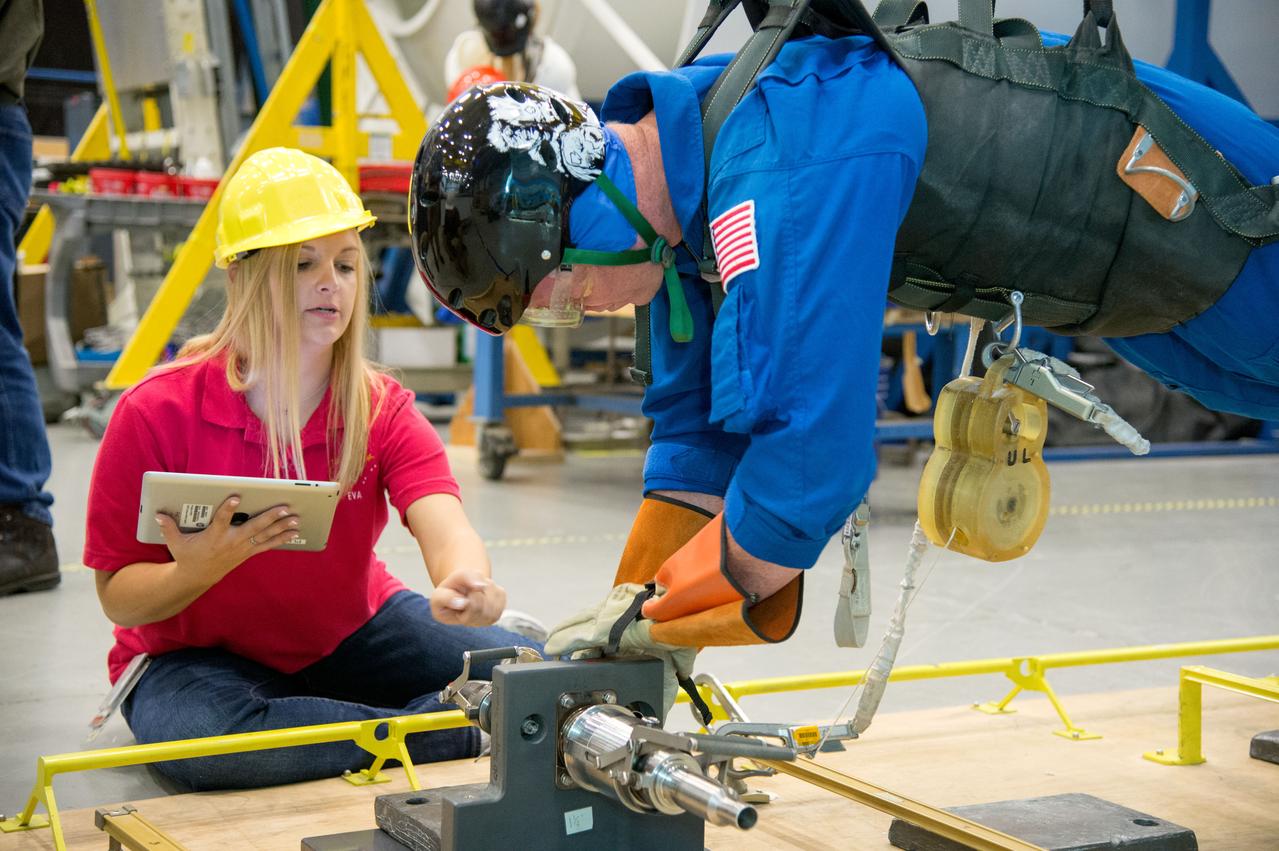 PHOTO DATE: 29 July 2013 LOCATION: Bldg. 9NW, Space Vehicle Mockup Training Facility - POGO SUBJECT: Expedition 42 crew member and astronaut Barry "Butch" Wilmore during ISS EVA POGO 1 training. Instructors Faruq Sabur (black shirt), Allissa Battocletti (red shirt), Sandy Fletcher (light blue shirt with glasses) and astronaut Shane Kimbrough assist.  PHOTOGRAPHER: Mark Sowa