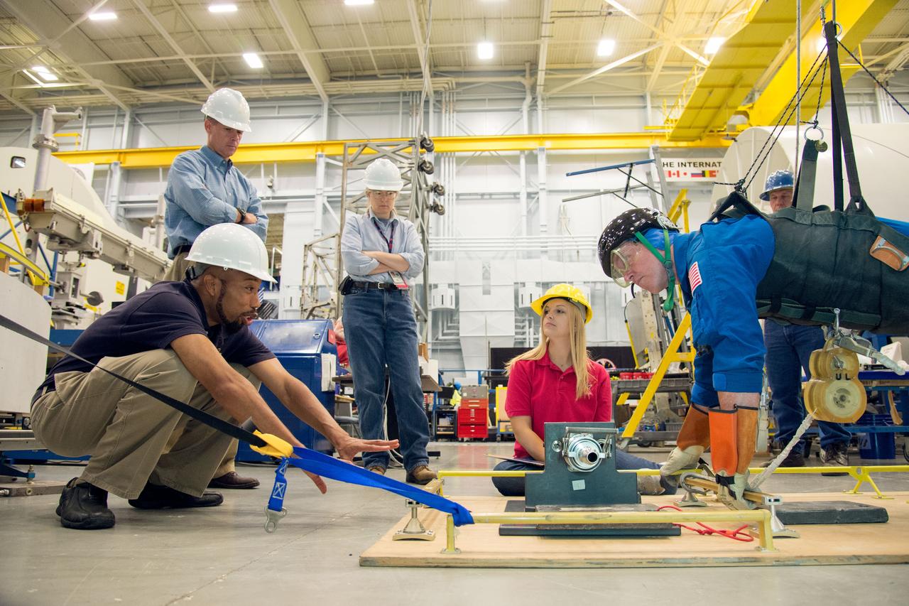PHOTO DATE: 29 July 2013 LOCATION: Bldg. 9NW, Space Vehicle Mockup Training Facility - POGO SUBJECT: Expedition 42 crew member and astronaut Barry "Butch" Wilmore during ISS EVA POGO 1 training. Instructors Faruq Sabur (black shirt), Allissa Battocletti (red shirt), Sandy Fletcher (light blue shirt with glasses) and astronaut Shane Kimbrough assist.  PHOTOGRAPHER: Mark Sowa