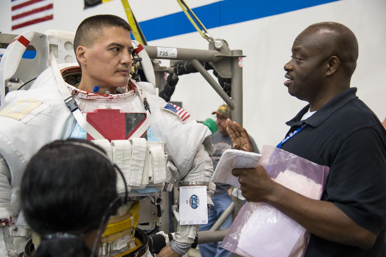 PHOTO DATE:  08-08-13 LOCATION:  NBL - Pool Topside SUBJECT: Expedition 44 crew members Kjell Lindren and Kimiya Yui (JAXA) during INC-44 ISS EVA Maintence PHOTOGRAPHER: BILL STAFFORD