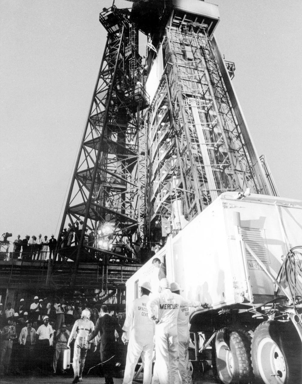 JSC2013-E-076221 (15 May 1963) --- Astronaut L. Gordon Cooper Jr. waited inside the transfer van for several minutes and then leaving the transfer van walked to the elevator which took him to the spacecraft "Faith 7" atop the Atlas vehicle for his mission. (63-MA9-132) Photo credit: NASA