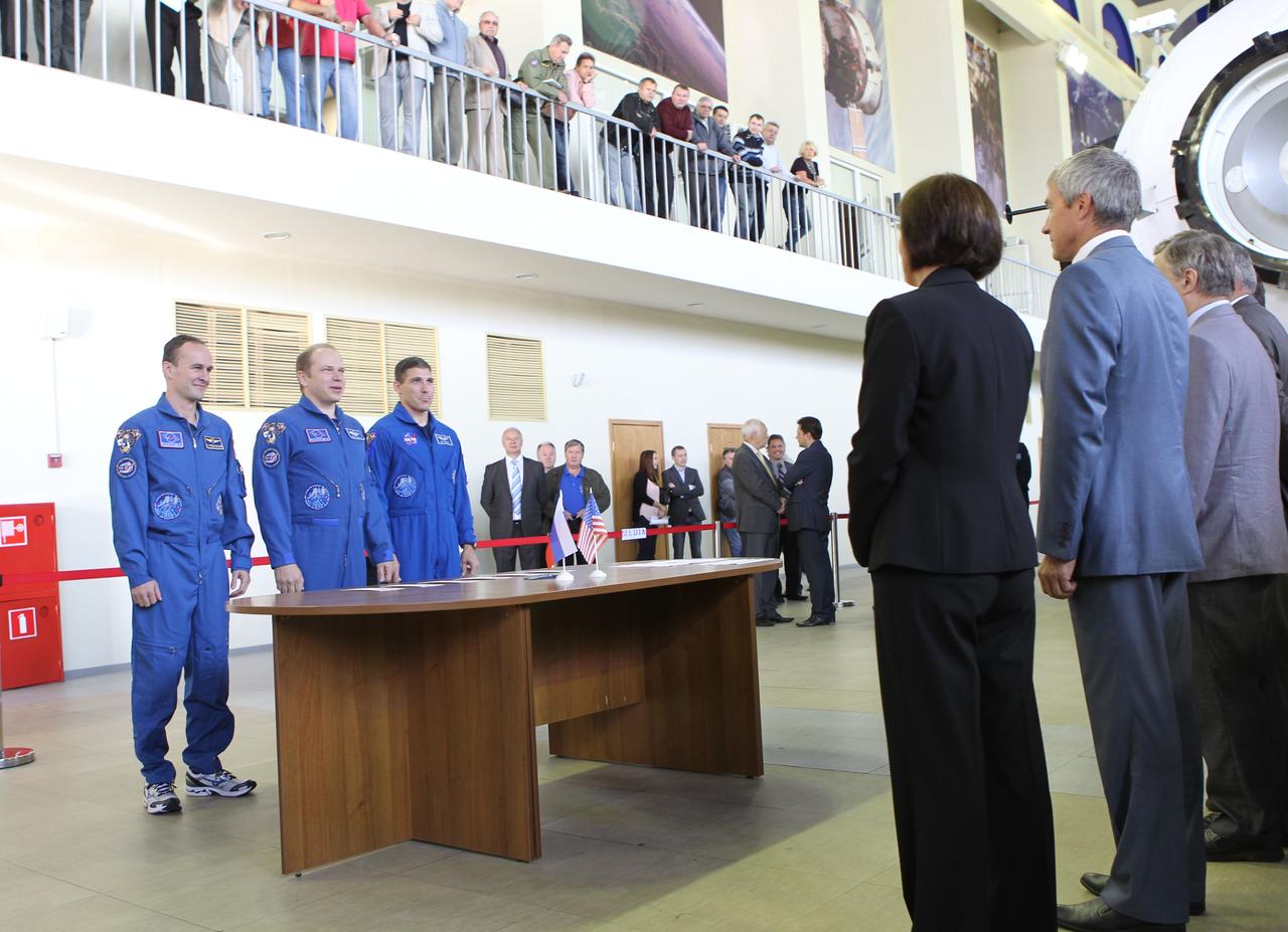 At the Gagarin Cosmonaut Training Center in Star City, Russia, the Expedition 37/38 prime crewmembers check in with Russian officials Sept. 3 prior to the start of a round of qualification exams for their launch to the International Space Station later this month. Flight Engineer Sergey Ryazanskiy (far left), Soyuz Commander Oleg Kotov (left and center) and NASA Flight Engineer Michael Hopkins (left and far right) are greeted by GCTC Director Sergei Krikalev (right in blue suit) and NASA astronaut Shannon Walker (right and to Krilkalev’s left). Kotov, Ryazanskiy and Hopkins are scheduled to launch Sept. 26 from the Baikonur Cosmodrome in Kazakhstan in their Soyuz TMA-10M spacecraft. NASA/Stephanie Stoll