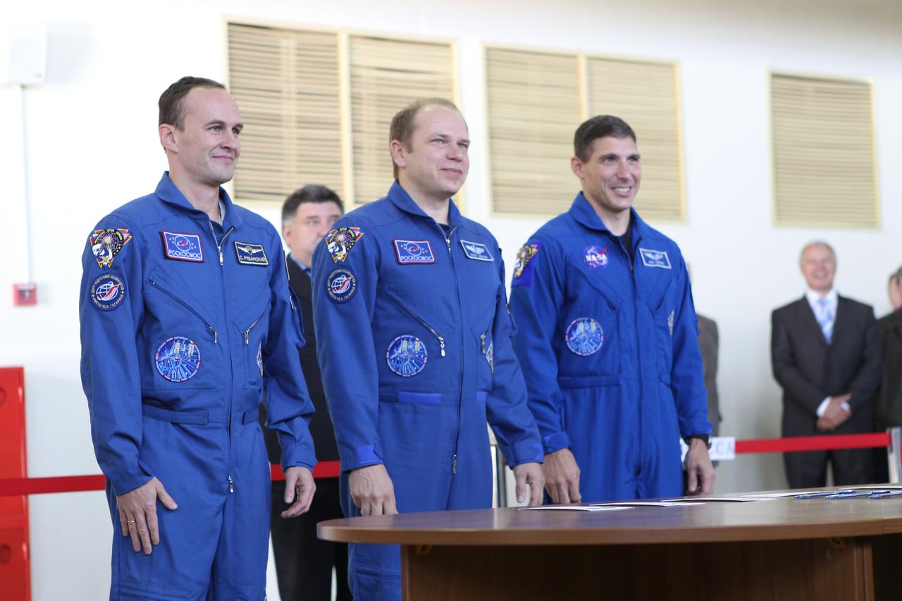 At the Gagarin Cosmonaut Training Center in Star City, Russia, the Expedition 37/38 prime crewmembers check in with Russian officials Sept. 3 prior to the start of a round of qualification exams for their launch to the International Space Station later this month. Flight Engineer Sergey Ryazanskiy (left), Soyuz Commander Oleg Kotov (center) and NASA Flight Engineer Michael Hopkins (right) are in the final weeks of training for their launch Sept. 26 from the Baikonur Cosmodrome in Kazakhstan in their Soyuz TMA-10M spacecraft. NASA/Stephanie Stoll