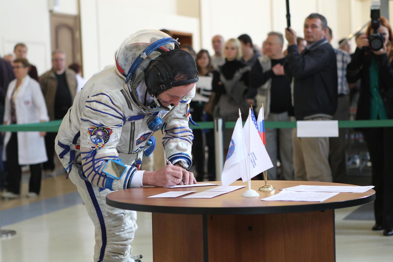 At the Gagarin Cosmonaut Training Center in Star City, Russia, Expedition 37/38 Flight Engineer Sergey Ryazanskiy signs in for a round of qualification exams Sept. 4 as he and his crewmates, Soyuz Commander Oleg Kotov and NASA Flight Engineer Michael Hopkins enter the final phase of their training. The trio is preparing for launch on Sept. 26, Kazakh time, from the Baikonur Cosmodrome in Kazakhstan on the Soyuz TMA-10M spacecraft for a 5 ½ month mission on the International Space Station. NASA/Stephanie Stoll