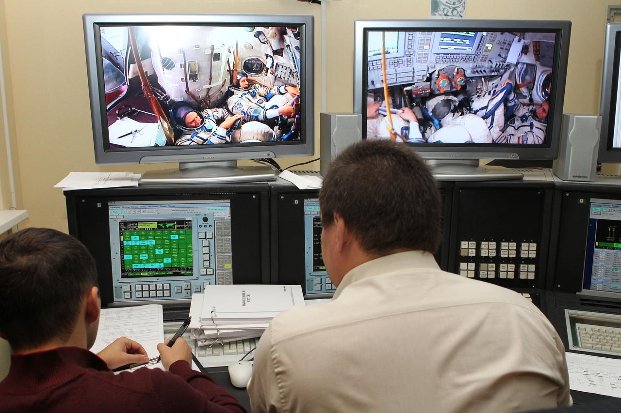 At the Gagarin Cosmonaut Training Center in Star City, Russia, Russian instructors monitor the performance of Expedition 37/38 Soyuz Commander Oleg Kotov, Flight Engineer Michael Hopkins of NASA and Flight Engineer Sergey Ryazanskiy Sept. 4 as they conducted a qualification exam in a Soyuz spacecraft simulator. The trio is in final training for launch on Sept. 26, Kazakh time, from the Baikonur Cosmodrome in Kazakhstan on the Soyuz TMA-10M spacecraft for a 5 ½ month mission on the International Space Station. NASA/Stephanie Stoll