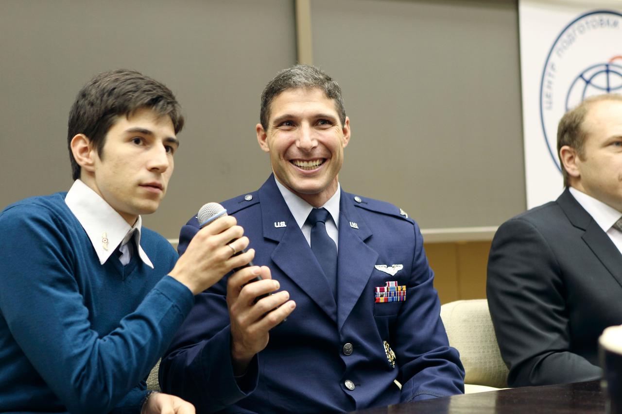 At the Gagarin Cosmonaut Training Center in Star City, Russia, Expedition 37/38 Flight Engineer Michael Hopkins of NASA hands the microphone to an interpreters after answering a question from a reporter at a pre-launch news conference Sept. 6 as his crewmate, Soyuz Commander Oleg Kotov (right) looks on. Along with Flight Engineer Sergey Ryazanskiy, Hopkins and Kotov are preparing for their launch to the International Space Station from the Baikonur Cosmodrome in Kazakhstan on Sept. 26, Kazakh time, aboard the Soyuz TMA-10M spacecraft.  NASA/Stephanie Stoll