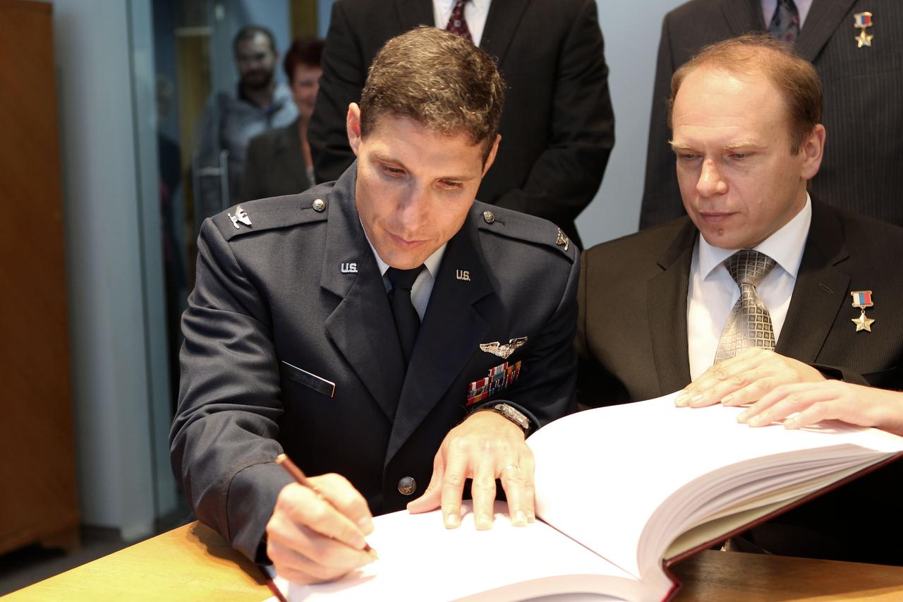 At the Gagarin Cosmonaut Training Center in Star City, Russia, Expedition 37/38 Flight Engineer Michael Hopkins of NASA (left) signs a certification book in a traditional ceremony Sept. 6 as his Soyuz Commander, Oleg Kotov (right) looks on. Hopkins, Kotov and Flight Engineer Sergey Ryazanskiy are preparing for their launch to the International Space Station from the Baikonur Cosmodrome in Kazakhstan on Sept. 26, Kazakh time, aboard the Soyuz TMA-10M spacecraft.  NASA/Stephanie Stoll