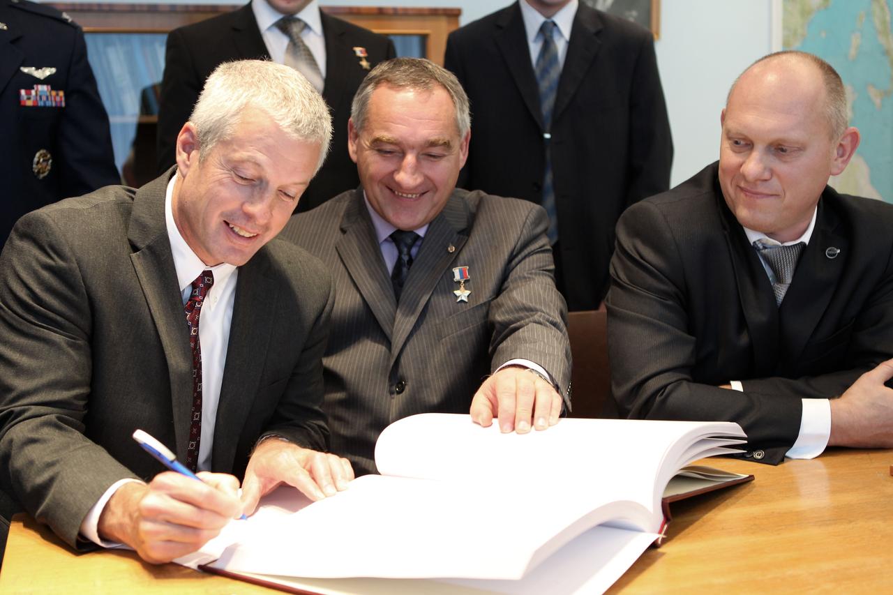 At the Gagarin Cosmonaut Training Center in Star City, Russia, Expedition 37/38 backup Flight Engineer Steve Swanson of NASA (left) signs a certification book in a traditional ceremony Sept. 6 as his Soyuz Commander, Alexander Skvortsov (center) and backup Flight Engineer Oleg Artemyev (right) look on. The trio is serving as backups to the prime crewmembers --- NASA Flight Engineer Michael Hopkins of NASA, Soyuz Commander Oleg Kotov and Flight Engineer Sergey Ryazanskiy, who are preparing for their launch to the International Space Station from the Baikonur Cosmodrome in Kazakhstan on Sept. 26, Kazakh time, aboard the Soyuz TMA-10M spacecraft.  NASA/Stephanie Stoll