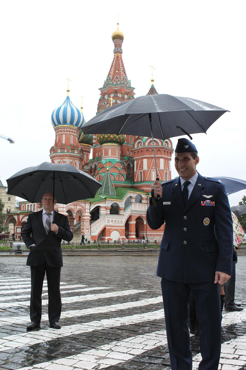On a rainy day at Red Square in Moscow, Expedition 37/38 Flight Engineer Michael Hopkins of NASA poses for pictures Sept. 6 in front of St. Basil’s Cathedral during a traditional trip to lay flowers at the Kremlin Wall where Russian space icons are interred. In the background is backup crewmember Oleg Artemyev. Hopkins, Soyuz Commander Oleg Kotov and Flight Engineer Sergey Ryazanskiy are preparing for their launch to the International Space Station from the Baikonur Cosmodrome in Kazakhstan on Sept. 26, Kazakh time, aboard the Soyuz TMA-10M spacecraft.  NASA/Stephanie Stoll