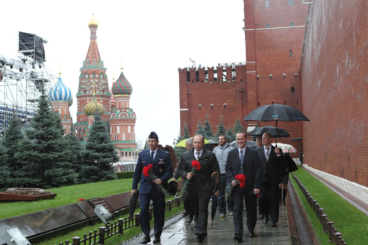 With the onion dome spires of St. Basil’s Cathedral serving as a backdrop, Expedition 37/38 Flight Engineer Michael Hopkins of NASA (front row, left), Soyuz Commander Oleg Kotov (front row, center) and Flight Engineer Sergey Ryazanskiy (front row, right) lead the way along the Kremlin Wall in Red Square in Moscow to lay flowers Sept. 6 in a traditional ceremony to honor Russian space icons who are interred there. Kotov, Hopkins and Ryazanskiy are preparing for their launch to the International Space Station from the Baikonur Cosmodrome in Kazakhstan on Sept. 26, Kazakh time, aboard the Soyuz TMA-10M spacecraft.  NASA/Stephanie Stoll