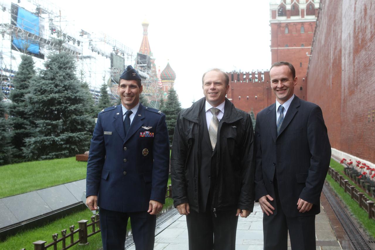 At the Kremlin Wall at Red Square in Moscow, Expedition 37/38 Flight Engineer Michael Hopkins of NASA (left), Soyuz Commander Oleg Kotov (center) and Flight Engineer Sergey Ryazanskiy (right) pose for pictures Sept. 6 during the traditional visit to lay flowers at the wall where Russian space icons are interred. Hopkins, Kotov and Ryazanskiy are preparing for their launch to the International Space Station from the Baikonur Cosmodrome in Kazakhstan on Sept. 26, Kazakh time, aboard the Soyuz TMA-10M spacecraft.  NASA/Stephanie Stoll