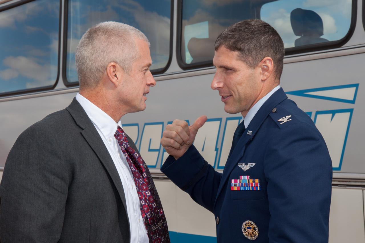 Expedition 37/38 prime Flight Engineer Michael Hopkins of NASA (right) exchanges information with his backup, Steve Swanson of NASA (left) after arriving with their crewmates in Baikonur, Kazakhstan on a flight from their training base outside of Moscow. Hopkins, Soyuz Commander Oleg Kotov and Flight Engineer Sergey Ryazanskiy will launch from the Baikonur Cosmodrome Sept. 26, Kazakh time, in the Soyuz TMA-10M spacecraft for a five and a half month mission on the International Space Station.  NASA/Victor Zelentsov 