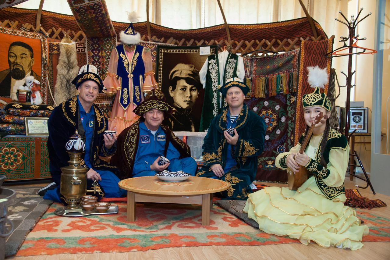 Dressed in traditional Kazakh garb, Expedition 37/38 backup crewmembers Steve Swanson of NASA (left), Alexander Skvortsov (center) and Oleg Artemyev (right) enjoy festivities and a Kazakh meal in Baikonur, Kazakhstan Sept. 17. Swanson, Skvortsov and Artemyev are serving as backups to the prime crewmembers, Flight Engineer Michael Hopkins of NASA, Soyuz Commander Oleg Kotov and Flight Engineer Sergey Ryazanskiy, who are preparing for launch Sept. 26, Kazakh time from the Baikonur Cosmodrome in the Soyuz TMA-10M spacecraft for a five and a half month mission on the International Space Station. NASA/Victor Zelentsov