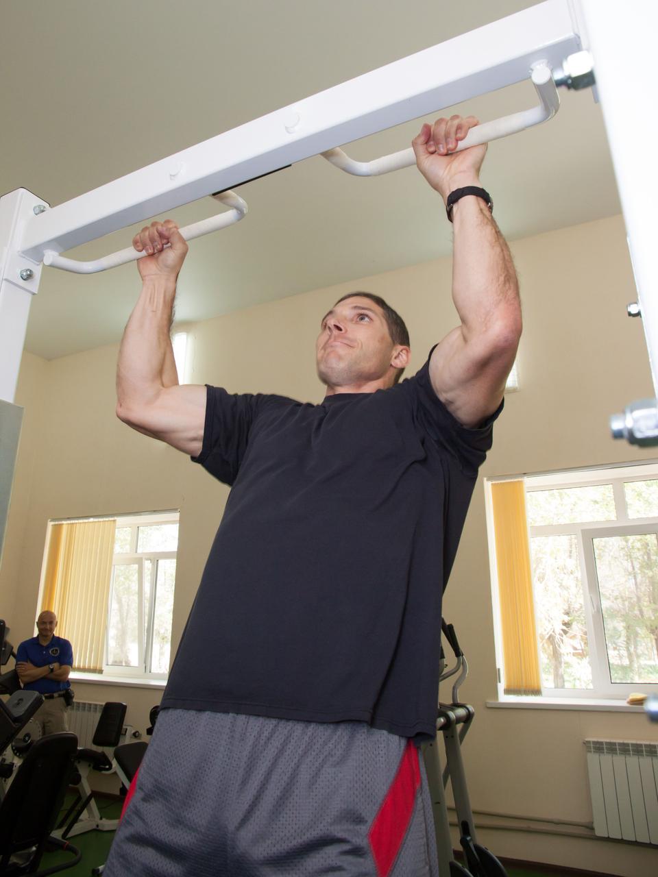 At his Cosmonaut Hotel crew quarters in Baikonur, Kazakhstan, Expedition 37/38 Flight Engineer Michael Hopkins of NASA conducts a series of chin up exercises Sept. 18. Hopkins, Soyuz Commander Oleg Kotov and Flight Engineer Sergey Ryazanskiy are set to launch Sept. 26, Kazakh time, from the Baikonur Cosmodrome on their Soyuz TMA-10M spacecraft for a five and a half month mission on the International Space Station.  NASA/Victor Zelentsov 