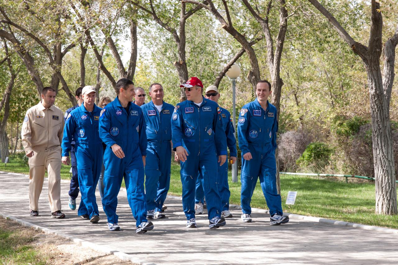 Expedition 37/38 Flight Engineer Michael Hopkins of NASA (front row, left), Soyuz Commander Oleg Kotov (front row, center) and Flight Engineer Sergey Ryazanskiy (front row, right) lead a procession down the “Walk of Cosmonauts” behind their Cosmonaut Hotel crew quarters in Baikonur, Kazakhstan Sept. 18. Behind the trio are their backups from left to right, Steve Swanson of NASA, Alexander Skvortsov and Oleg Artemyev. Hopkins, Kotov and Ryazanskiy are set to launch Sept. 26, Kazakh time, from the Baikonur Cosmodrome on their Soyuz TMA-10M spacecraft for a five and a half month mission on the International Space Station.  NASA/Victor Zelentsov 