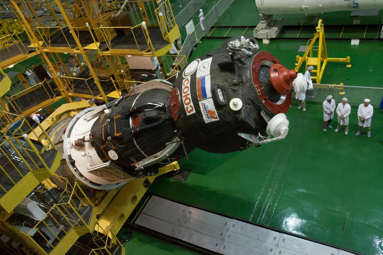 In the Integration Facility at the Baikonur Cosmodrome in Kazakhstan, the Soyuz TMA-10M spacecraft is lowered into place for its encapsulation in the third stage of a Soyuz rocket Sept. 19. The Soyuz spacecraft will move to its launch pad Sept. 23 for final preparations for launch Sept. 26, Kazakh time, to carry Expedition 37/38 Flight Engineer Michael Hopkins of NASA, Soyuz Commander Oleg Kotov and Flight Engineer Sergey Ryazanskiy into orbit for the start of a five and a half month mission on the International Space Station.  NASA/Victor Zelentsov 