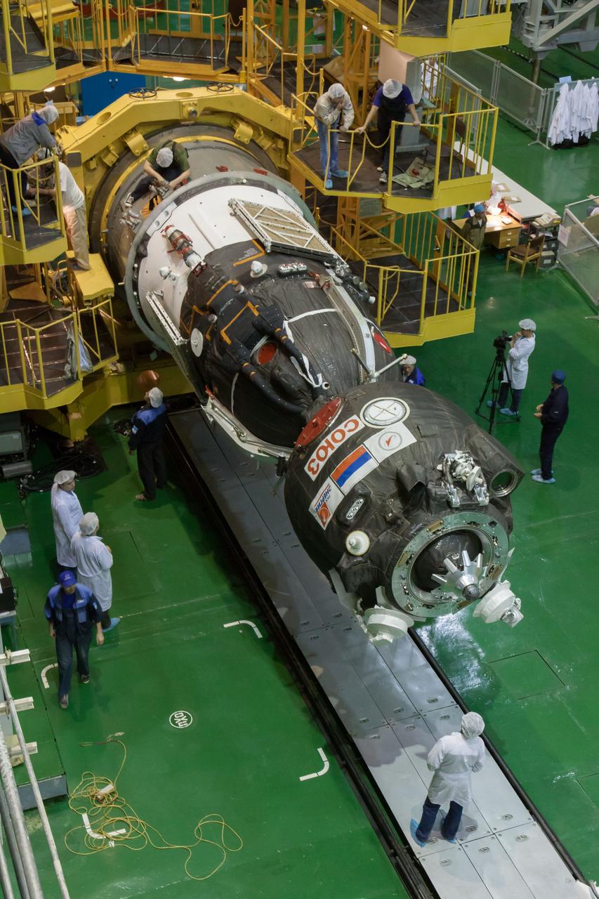 In the Integration Facility at the Baikonur Cosmodrome in Kazakhstan, the Soyuz TMA-10M spacecraft is readied for its encapsulation in the third stage of a Soyuz rocket Sept. 19. The Soyuz spacecraft will move to its launch pad Sept. 23 for final preparations for launch Sept. 26, Kazakh time, to carry Expedition 37/38 Flight Engineer Michael Hopkins of NASA, Soyuz Commander Oleg Kotov and Flight Engineer Sergey Ryazanskiy into orbit for the start of a five and a half month mission on the International Space Station.  NASA/Victor Zelentsov 