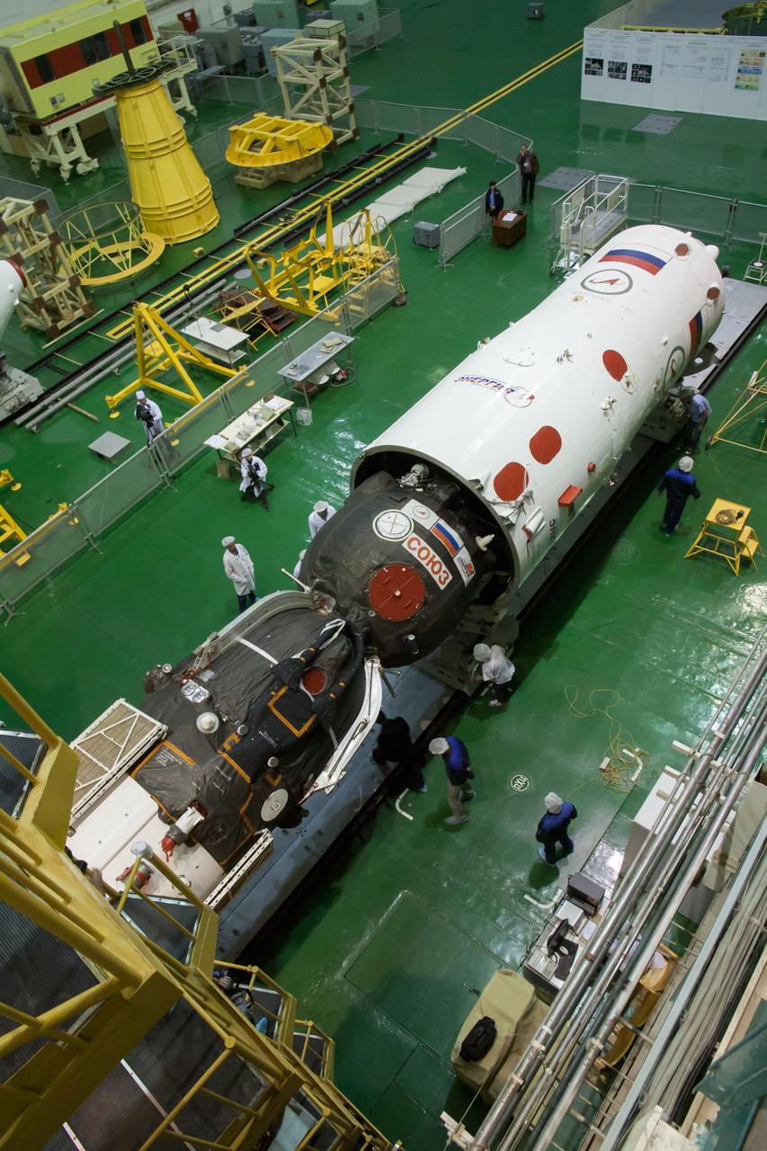 In the Integration Facility at the Baikonur Cosmodrome in Kazakhstan, the Soyuz TMA-10M spacecraft is installed in the third stage of a Soyuz rocket Sept. 19. The Soyuz spacecraft will move to its launch pad Sept. 23 for final preparations for launch Sept. 26, Kazakh time, to carry Expedition 37/38 Flight Engineer Michael Hopkins of NASA, Soyuz Commander Oleg Kotov and Flight Engineer Sergey Ryazanskiy into orbit for the start of a five and a half month mission on the International Space Station.  NASA/Victor Zelentsov 