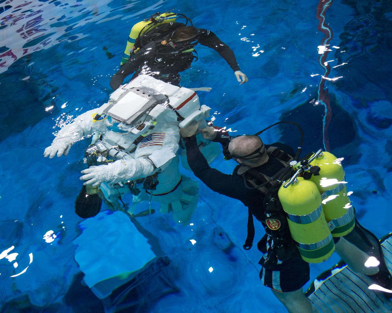 PHOTO DATE:  09-17-13 LOCATION: NBL - Pool Topside  SUBJECT: Expedition 40/41 crew members Greg Wiseman and Alexander Gerst during pre-dive briefing, preparations and suitup, then lowering into the water. PHOTOGRAPHER: BILL STAFFORD