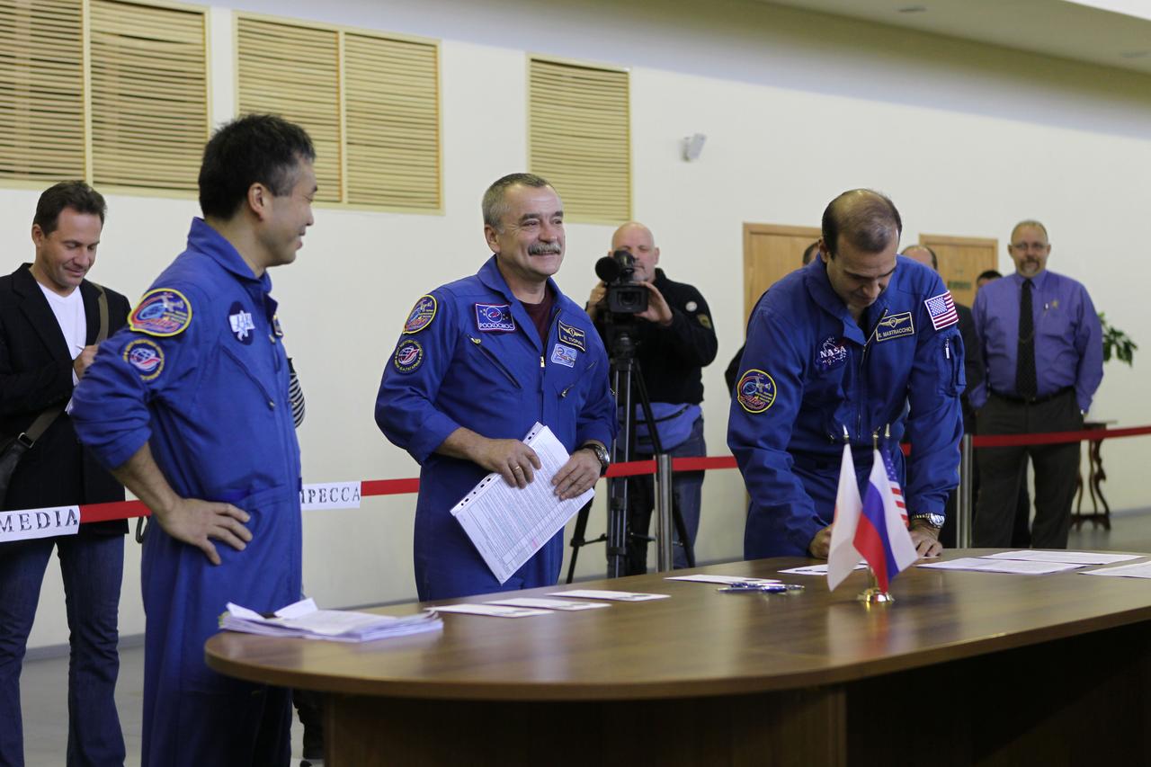 At the Gagarin Cosmonaut Training Center in Star City, Russia, Expedition 38/39 Flight Engineer Rick Mastracchio of NASA (right) signs in for the start of flight qualifications exam simulations Oct. 15, 2013 as his crewmates, Flight Engineer Koichi Wakata of the Japan Aerospace Exploration Agency (left) and Soyuz Commander Mikhail Tyurin (center) look on. Also on hand was Expedition 39 Lead Flight Director Royce Renfrew of NASA (far right). Tyurin, Wakata and Mastracchio are scheduled to launch on Nov. 7, local time, from the Baikonur Cosmodrome in Kazakhstan on the Soyuz TMA-11M spacecraft for a six-month mission on the International Space Station.  NASA/Stephanie Stoll 