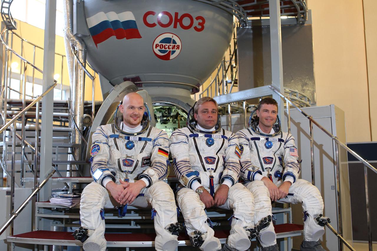 At the Gagarin Cosmonaut Training Center in Star City, Russia, Expedition 38/39 backup crewmembers Flight Engineer Alexander Gerst of the European Space Agency (left), Soyuz Commander Max Suraev (center) and NASA Flight Engineer Reid Wiseman (right) pose for pictures in front of a Soyuz simulator Oct. 18, 2013 as they participated in qualification exam simulations. They are backing up the prime crewmembers, NASA Flight Engineer Rick Mastracchio, Soyuz Commander Mikhail Tyurin and Flight Engineer Koichi Wakata of the Japan Aerospace Exploration Agency, who are scheduled to launch on Nov. 7, local time, from the Baikonur Cosmodrome in Kazakhstan on the Soyuz TMA-11M spacecraft for a six-month mission on the International Space Station.  NASA/Stephanie Stoll 