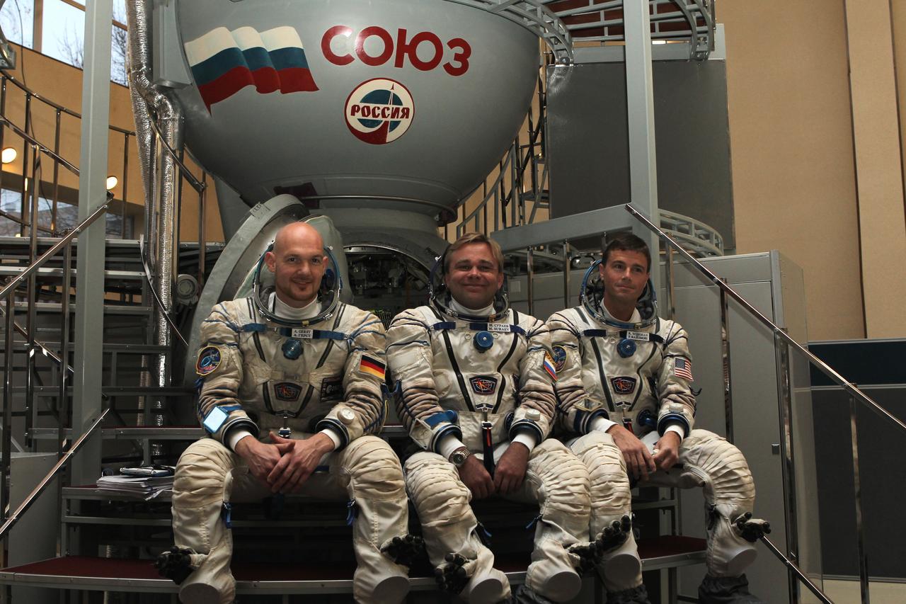 At the Gagarin Cosmonaut Training Center in Star City, Russia, Expedition 38/39 backup crewmembers Flight Engineer Alexander Gerst of the European Space Agency (left), Soyuz Commander Max Suraev (center) and NASA Flight Engineer Reid Wiseman (right) pose for pictures in front of a Soyuz simulator Oct. 18, 2013 as they participated in qualification exam simulations. They are backing up the prime crewmembers, NASA Flight Engineer Rick Mastracchio, Soyuz Commander Mikhail Tyurin and Flight Engineer Koichi Wakata of the Japan Aerospace Exploration Agency, who are scheduled to launch on Nov. 7, local time, from the Baikonur Cosmodrome in Kazakhstan on the Soyuz TMA-11M spacecraft for a six-month mission on the International Space Station.  NASA/Stephanie Stoll 