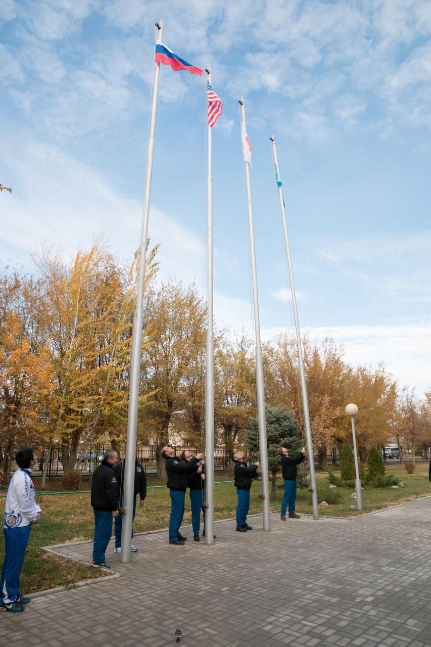 Outside their Cosmonaut Hotel crew quarters in Baikonur, Kazakhstan, the Expedition 38/39 prime and backup crewmembers participated in the traditional flag-raising ceremony October 27 as they conduct final pre-launch preparations. From left to right, prime Soyuz Commander Mikhail Tyurin and backup Max Suraev raise the Russian flag, prime Flight Engineer Rick Mastracchio of NASA and backup Reid Wiseman of NASA raise the U.S. flag, prime Flight Engineer Koichi Wakata of the Japan Aerospace Exploration Agency raises the Japanese flag and backup Flight Engineer Alexander Gerst of the European Space Agency raises the flag of Kazakhstan. Wakata, Tyurin and Mastracchio will launch Nov. 7, Kazakh time, in the Soyuz TMA-11M spacecraft from Baikonur to begin a six-month mission on the International Space Station.  NASA/Victor Zelentsov 
