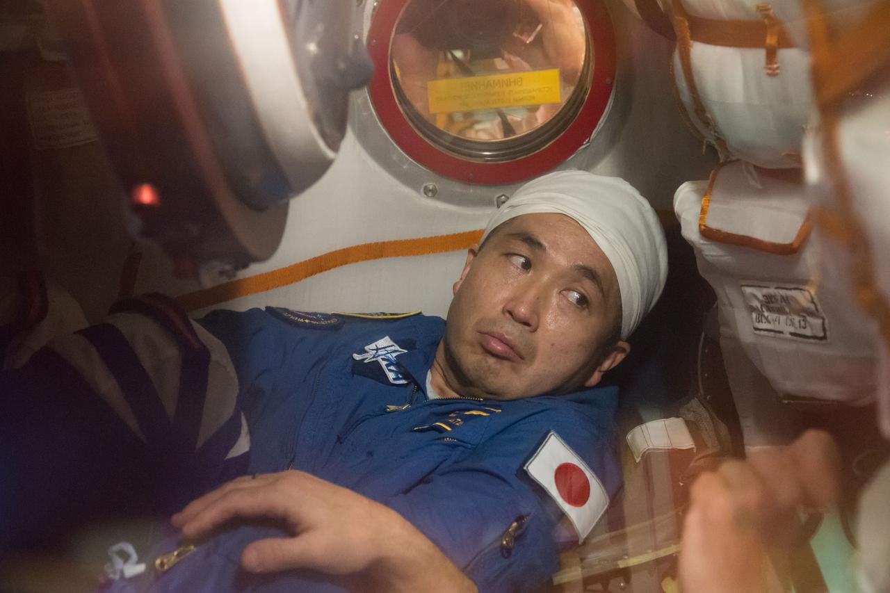 In the Integration Facility at the Baikonur Cosmodrome in Kazakhstan, Expedition 38/39 Flight Engineer Koichi Wakata of the Japan Aerospace Exploration Agency conducts a fit check dress rehearsal October 28 inside the Soyuz TMA-11M spacecraft. Wakata, Soyuz Commander Mikhail Tyurin and Flight Engineer Rick Mastracchio of NASA will launch Nov. 7, Kazakh time, in the Soyuz from Baikonur to begin a six-month mission on the International Space Station. NASA/Victor Zelentsov