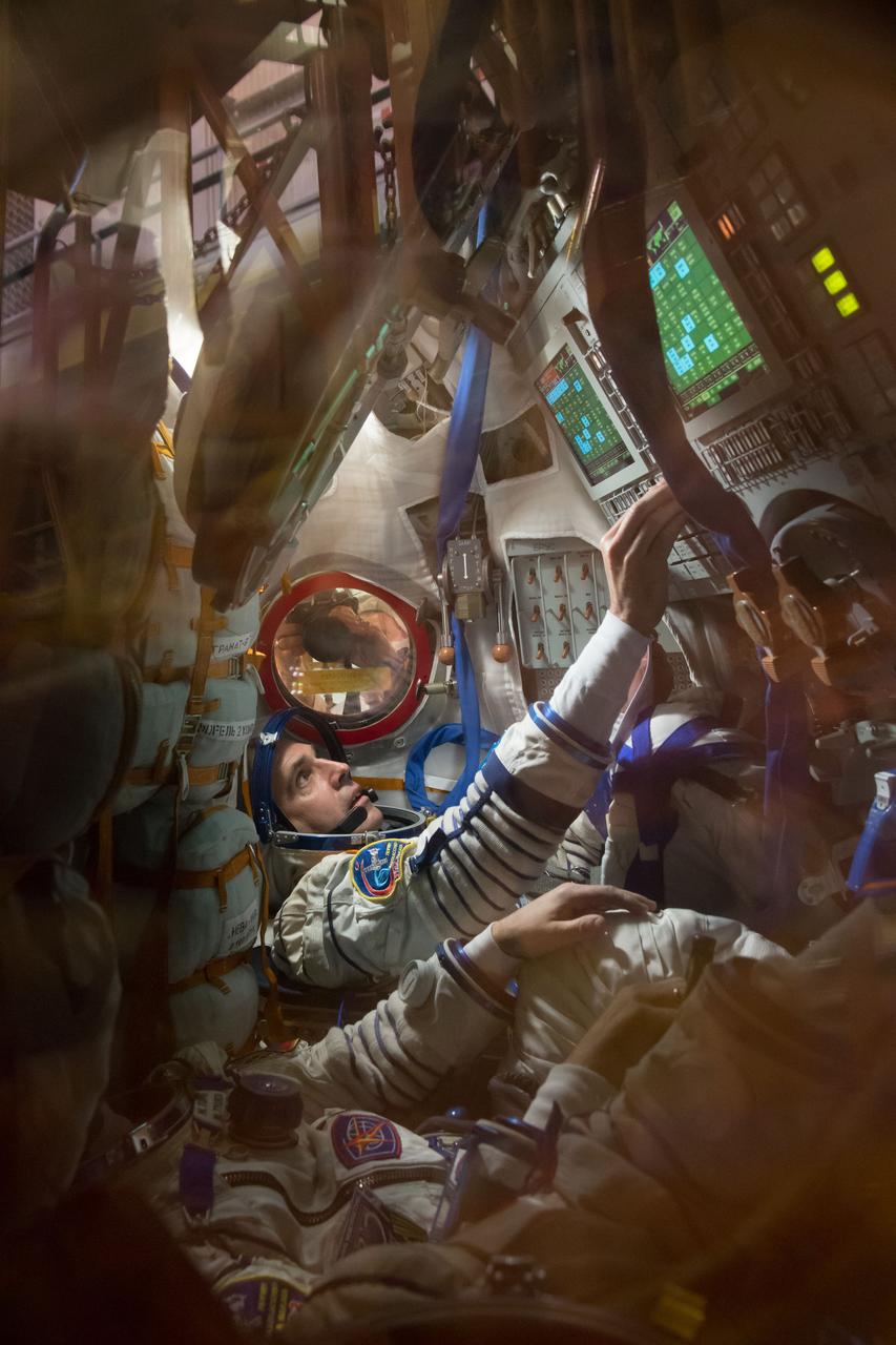 In the Integration Facility at the Baikonur Cosmodrome in Kazakhstan, Expedition 38/39 Flight Engineer Rick Mastracchio (top) participates in a fit check dress rehearsal October 28 in the Soyuz TMA-11M spacecraft with his crewmates, Soyuz Commander Mikhail Tyurin and Flight Engineer Koichi Wakata of the Japan Aerospace Exploration Agency. The trio will launch Nov. 7, Kazakh time, in the Soyuz spacecraft from Baikonur to begin a six-month mission on the International Space Station. NASA/Victor Zelentsov