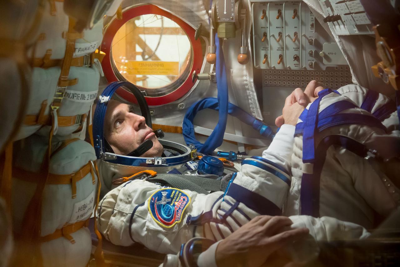 In the Integration Facility at the Baikonur Cosmodrome in Kazakhstan, Expedition 38/39 Flight Engineer Rick Mastracchio participates in a fit check dress rehearsal in the Soyuz TMA-11M spacecraft October 28 with his crewmates, Soyuz Commander Mikhail Tyurin and Flight Engineer Koichi Wakata of the Japan Aerospace Exploration Agency. The trio will launch Nov. 7, Kazakh time, in the Soyuz spacecraft from Baikonur to begin a six-month mission on the International Space Station. NASA/Victor Zelentsov
