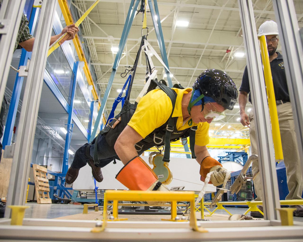  PHOTO DATE:  10-30-13 LOCATION:  Bldg. 9NW - POGO Stand  SUBJECT: Expedition 43 commander and crew member Terry Virts during his ISS EVA POGO 1 training on the POGO stand with instructors Faruq Sabur and Alexandros Kanelakos. PHOTOGRAPHER: BILL STAFFORD