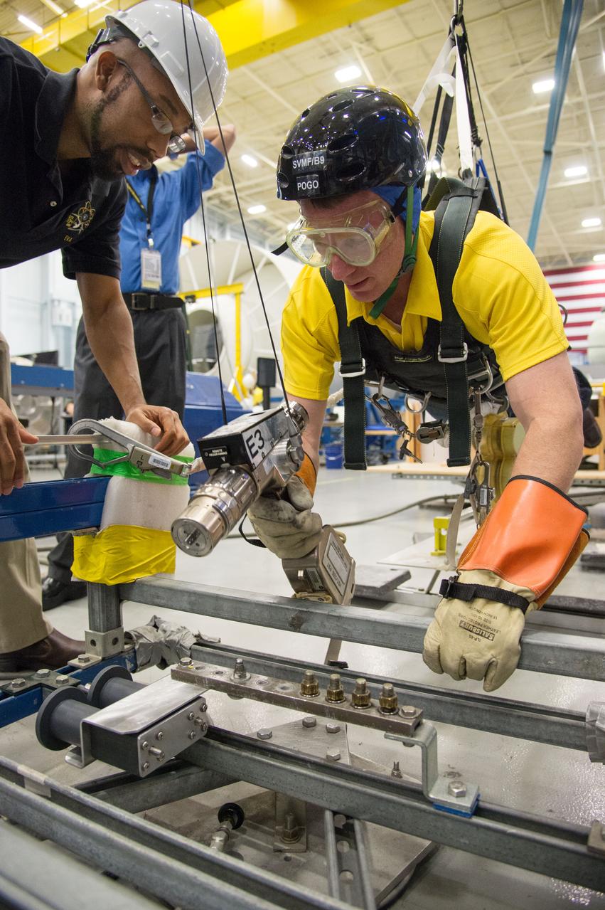  PHOTO DATE:  10-30-13 LOCATION:  Bldg. 9NW - POGO Stand  SUBJECT: Expedition 43 commander and crew member Terry Virts during his ISS EVA POGO 1 training on the POGO stand with instructors Faruq Sabur and Alexandros Kanelakos. PHOTOGRAPHER: BILL STAFFORD