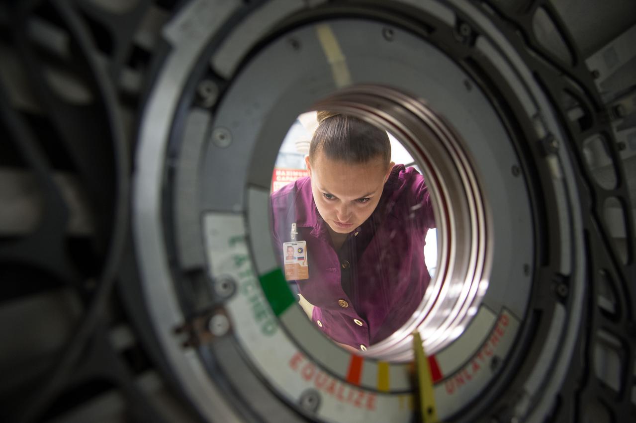 Date: 10-30-13 Location: Bldg 9NW, ISS Mockup Subject:  Expedition 41/42 crew member and RSA cosmonaut Elena Serova during rack and hatch skills training in ISS mockups.  Photographer: James Blair