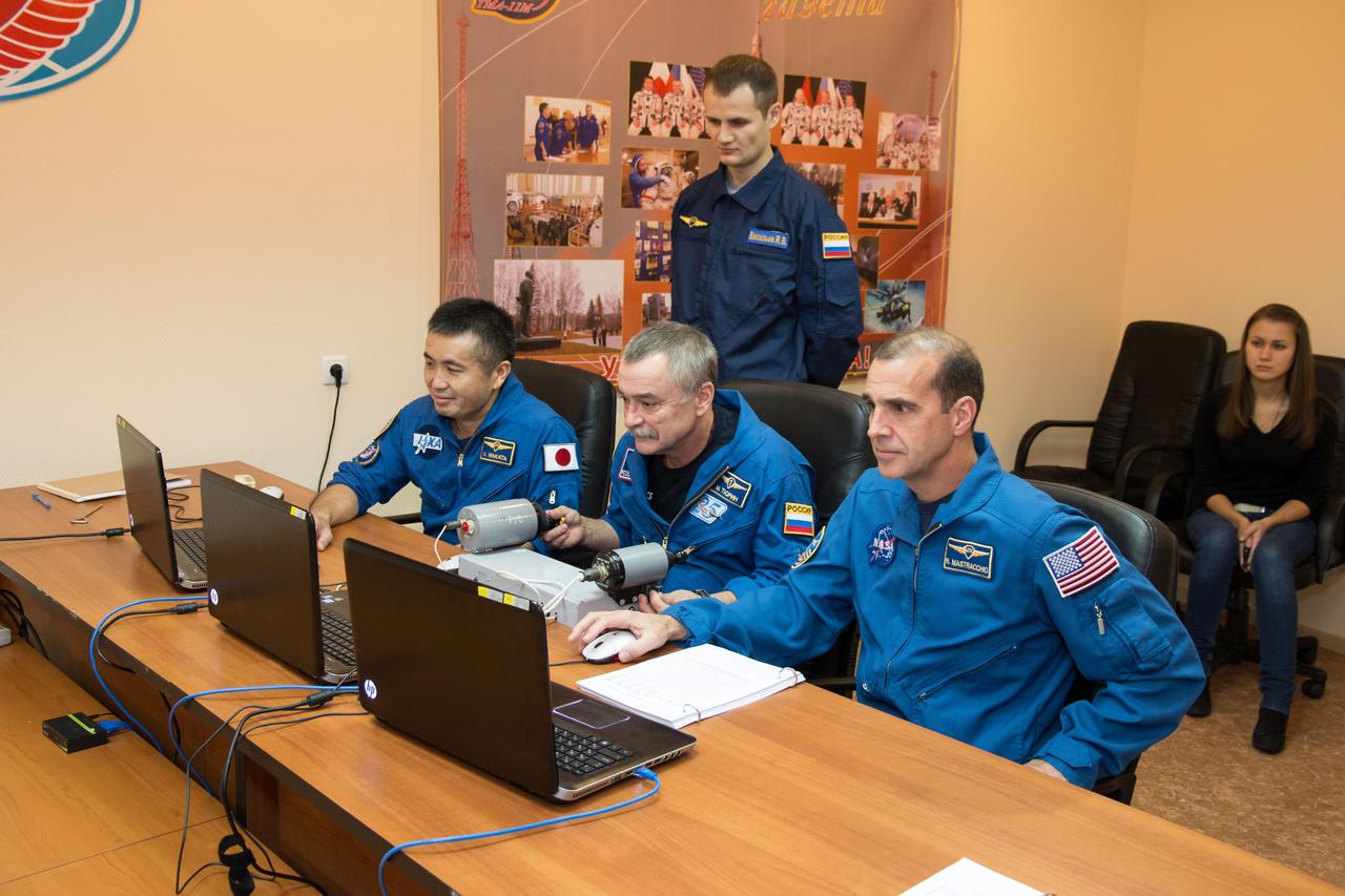 At their Cosmonaut Hotel crew quarters in Baikonur, Kazakhstan, Expedition 38/39 Flight Engineer Koichi Wakata of the Japan Aerospace Exploration Agency (left), Soyuz Commander Mikhail Tyurin (center) and Flight Engineer Rick Mastracchio of NASA (right) brush up on rendezvous techniques through the use of laptop computers Nov. 1 as they prepare for launch Nov. 7, Kazakh time, from the Baikonur Cosmodrome aboard the Soyuz TMA-11M spacecraft to begin a six-month mission on the International Space Station.  NASA/Victor Zelentsov 
