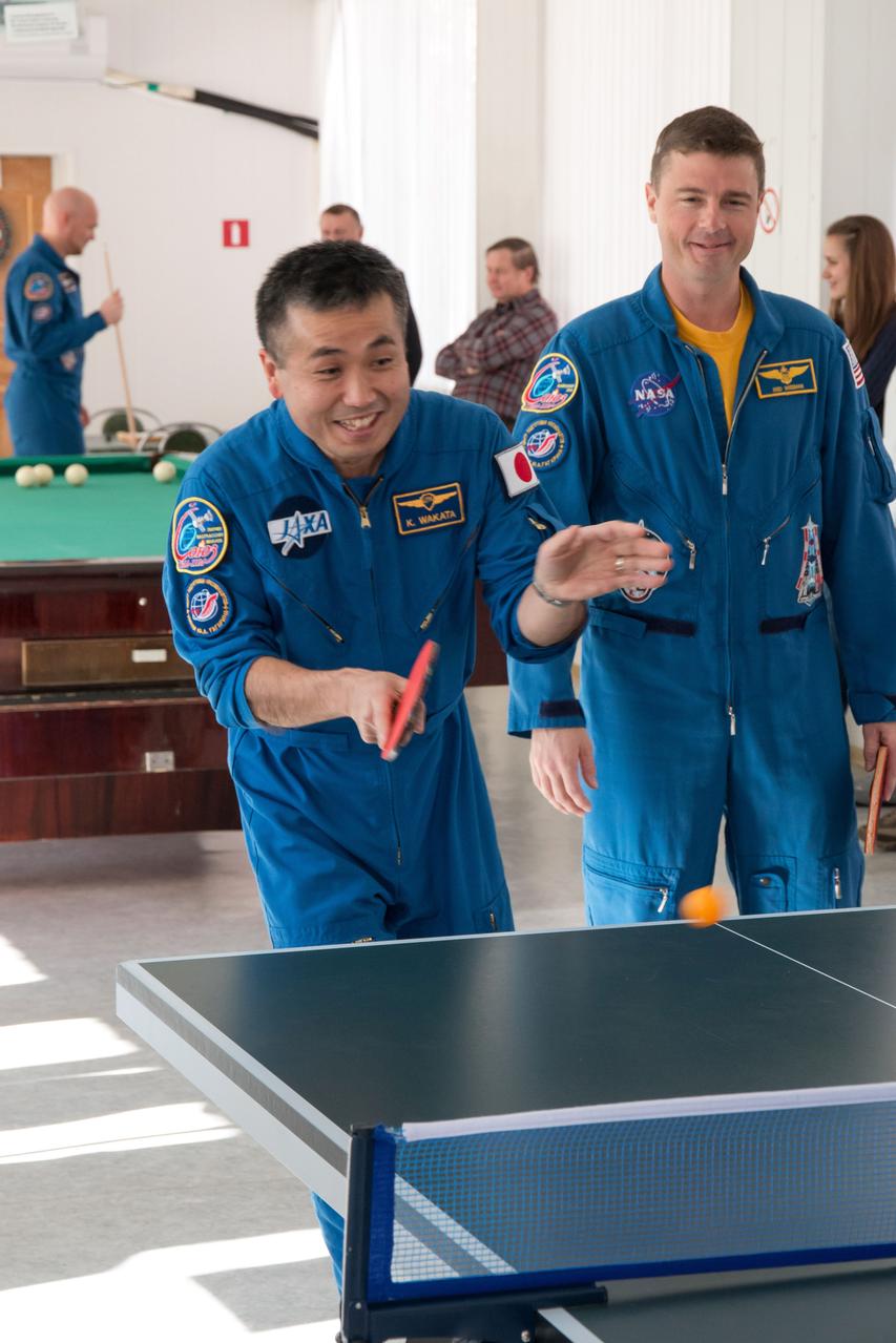 With backup crewmember Reid Wiseman (right) of NASA looking on, prime Expedition 38/39 Flight Engineer Koichi Wakata of the Japan Aerospace Exploration Agency (left) takes a turn at Ping-Pong Nov. 1 at the Cosmonaut Hotel crew quarters in Baikonur, Kazakhstan. Wakata, Soyuz Commander Mikhail Tyurin and Flight Engineer Rick Mastracchio of NASA are preparing for launch Nov. 7, Kazakh time, from the Baikonur Cosmodrome aboard the Soyuz TMA-11M spacecraft to begin a six-month mission on the International Space Station.  NASA/Victor Zelentsov 