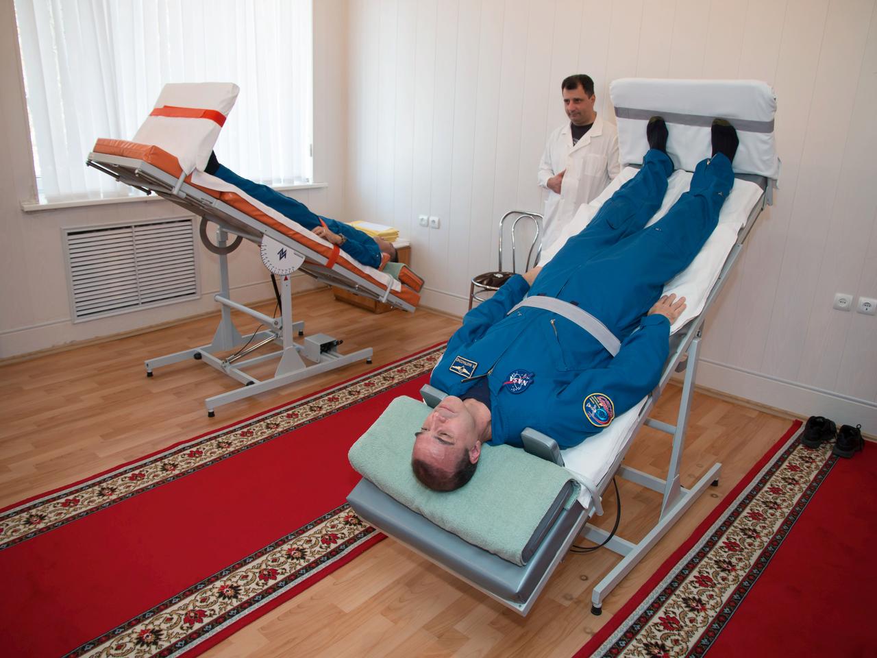 At the Cosmonaut Hotel crew quarters in Baikonur, Kazakhstan, Expedition 38/39 Flight Engineer Koichi Wakata (left) and Flight Engineer Rick Mastracchio (right) take turns on tilt tables Nov. 1 as they underwent physical conditioning for their launch Nov. 7, Kazakh time, with Soyuz Commander Mikhail Tyurin from the Baikonur Cosmodrome aboard the Soyuz TMA-11M spacecraft to begin a six-month mission on the International Space Station. NASA/Victor Zelentsov