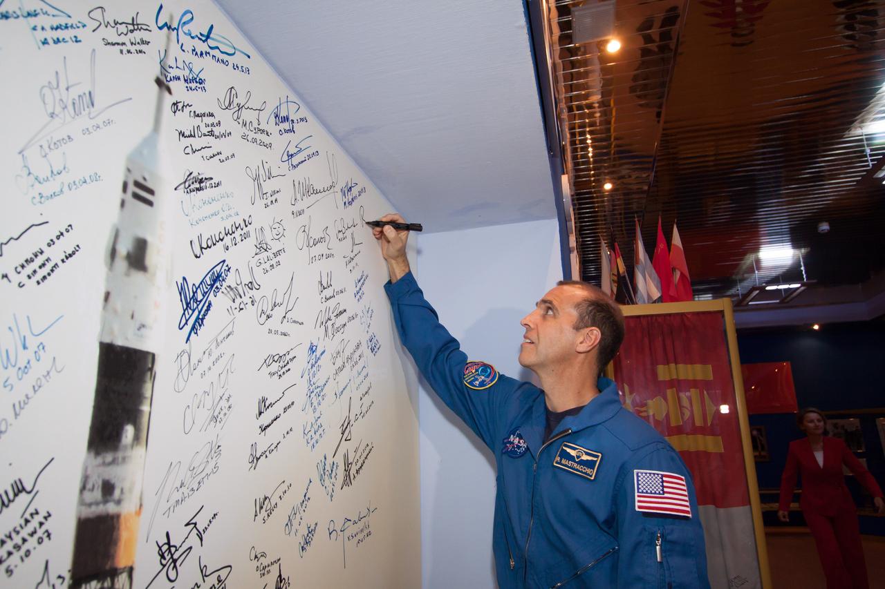 13-47-46-2:  At the Korolev Museum at the Baikonur Cosmodrome in Kazakhstan, Expedition 38/39 Flight Engineer Rick Mastracchio of NASA signs a wall mural of a Soyuz rocket launch during traditional pre-flight activities Nov. 3. Mastracchio, Soyuz Commander Mikhail Tyurin and Flight Engineer Koichi Wakata of the Japan Aerospace Exploration Agency will launch Nov. 7, Kazakh time, on the Soyuz TMA-11M spacecraft for a six-month mission on the International Space Station.  NASA/Victor Zelentsov 