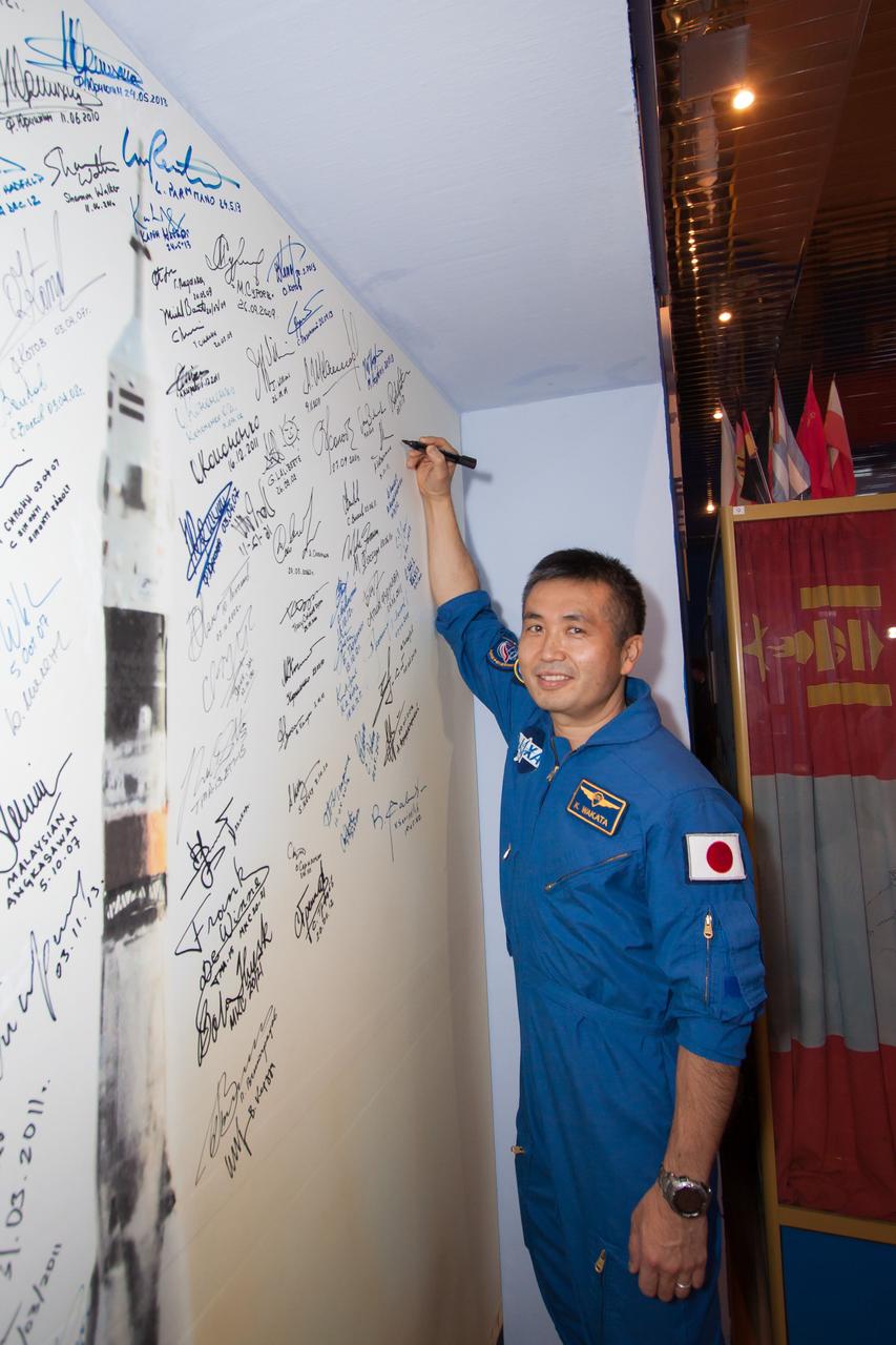 13-48-12:  At the Korolev Museum at the Baikonur Cosmodrome in Kazakhstan, Expedition 38/39 Flight Engineer Koichi Wakata of the Japan Aerospace Exploration Agency signs a wall mural of a Soyuz rocket launch during traditional pre-flight activities Nov. 3. Wakata, Soyuz Commander Mikhail Tyurin and Flight Engineer Rick Mastracchio of NASA will launch Nov. 7, Kazakh time, on the Soyuz TMA-11M spacecraft for a six-month mission on the International Space Station.  NASA/Victor Zelentsov 