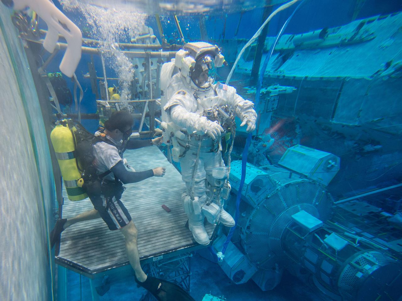 Date: 12-13-13 Location: NBL, Pool Topside Subject: Soyuz 45 crew members, Tim Kopra and ESA astronaut Tim Peake during ISS EVA Maintenance 1 - training at the NBL Photographer: James Blair/NASA