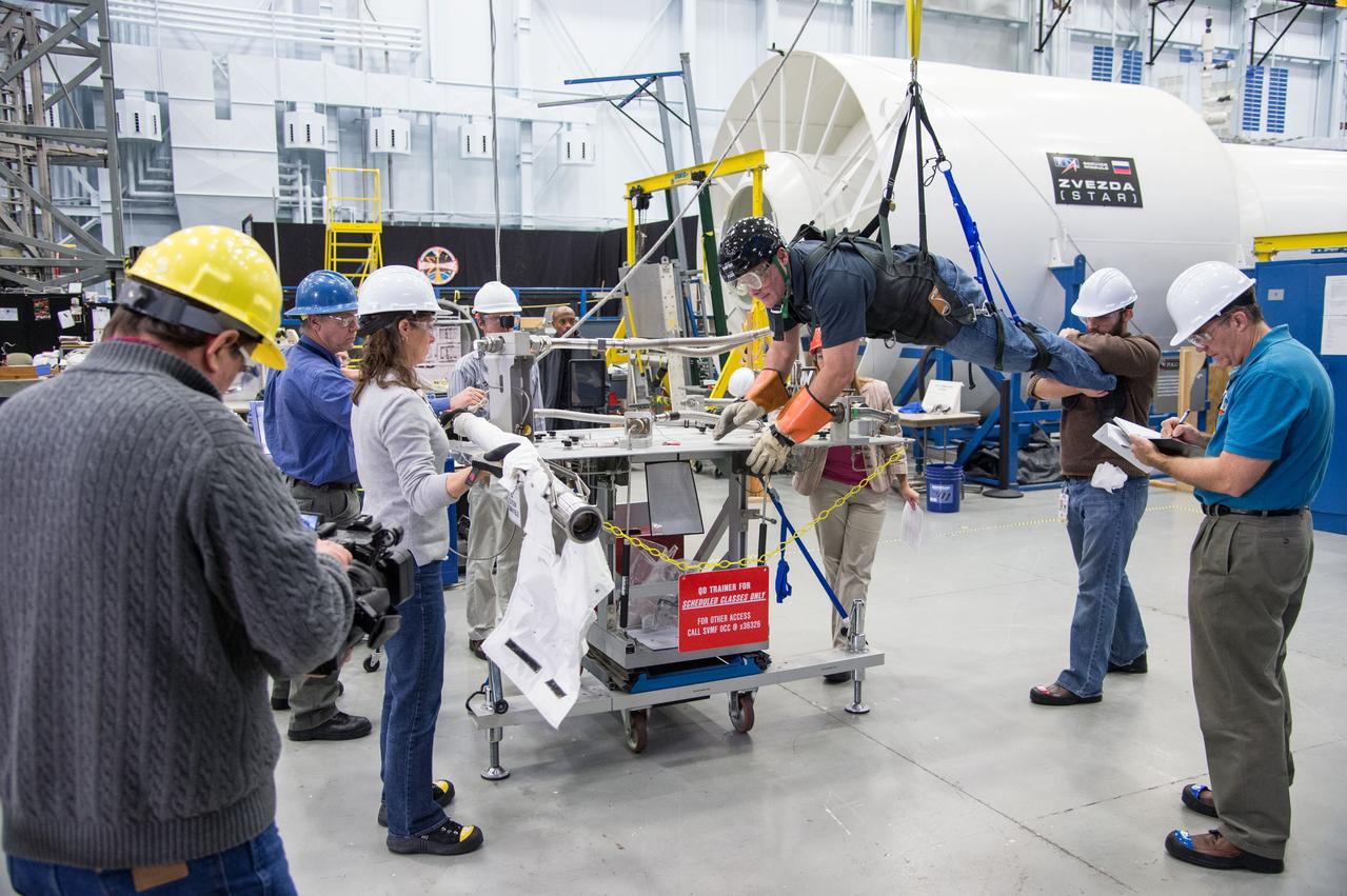 Date: 12/16/13 Location: Bldg 9NW, POGO Stand Subject: Doug Wheelock in POGO harness to evaluate EVA procedures and preparations for the ammonia coolant leak on ISS Photographer: James Blair/NASA