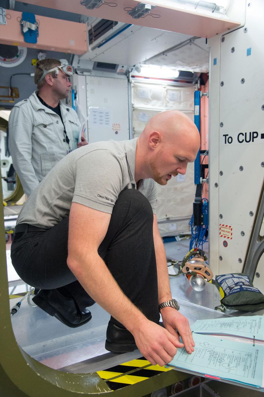 PHOTO DATE: 21 January 2014 LOCATION: Bldg. 9NW, Space Vehicle Mockup Training Facility - ISS Mockups SUBJECT: Expedition 41 six person crew emergency training scenarios. Crewmembers: 39S/Suraev, Wiseman and Gerst along with 40S/Wilmore, Samokutyaev, and Serova. PHOTOGRAPHER: Mark Sowa