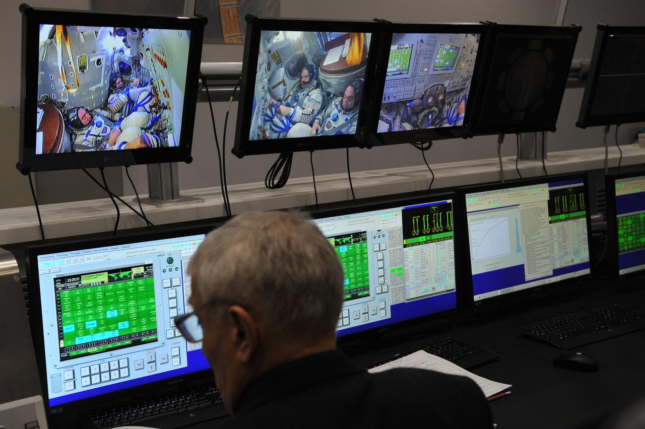 At the Gagarin Cosmonaut Training Center in Star City, Russia, a flight instructor monitors the progress of qualification exams for the Expedition 39/40 crewmembers March 5 as the crew heads into the homestretch of its training. Flight Engineer Steve Swanson of NASA, Soyuz Commander Alexander Skvortsov of Roscosmos and Oleg Artemyev of Roscosmos are preparing for their launch to the International Space Station from the Baikonur Cosmodrome in Star City, Russia March 26, Kazakh time, on the Soyuz TMA-12M spacecraft for a six-month mission.  NASA/Stephanie Stoll 
