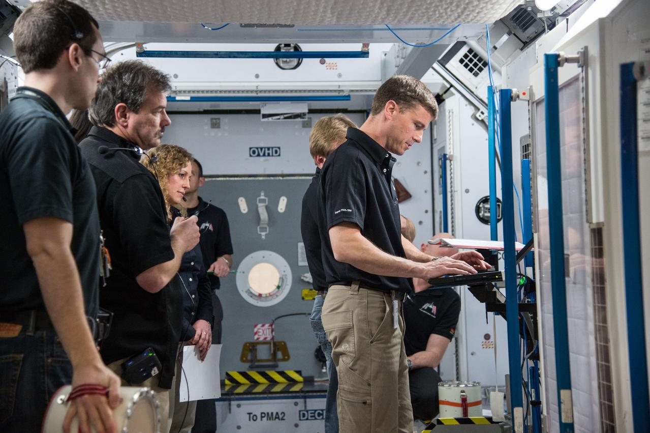PHOTO DATE:   03-12-14 LOCATION:   Bldg. 9NW - ISS Mockups SUBJECT: Expedition 41 crew (Soyuz 39)with Suraev, Wiseman, Gerst for 3 person emergency scenarios training in the ISS mockups. PHOTOGRAPHER:   BILL STAFFORD