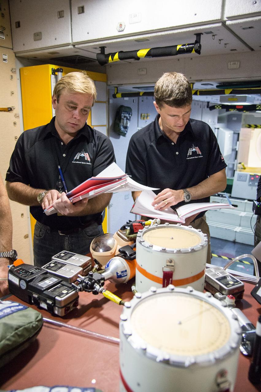 PHOTO DATE:   03-12-14 LOCATION:   Bldg. 9NW - ISS Mockups SUBJECT: Expedition 41 crew (Soyuz 39)with Suraev, Wiseman, Gerst for 3 person emergency scenarios training in the ISS mockups. PHOTOGRAPHER:   BILL STAFFORD