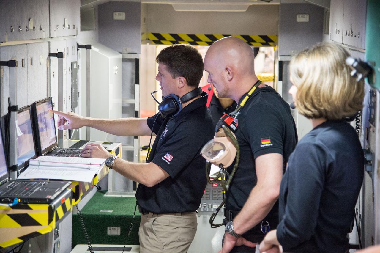PHOTO DATE:   03-12-14 LOCATION:   Bldg. 9NW - ISS Mockups SUBJECT: Expedition 41 crew (Soyuz 39)with Suraev, Wiseman, Gerst for 3 person emergency scenarios training in the ISS mockups. PHOTOGRAPHER:   BILL STAFFORD